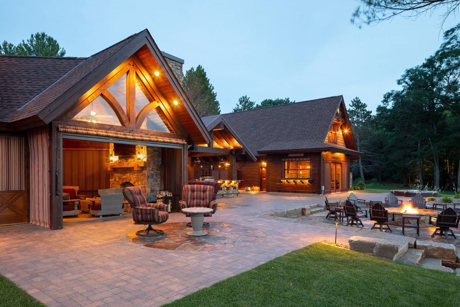 Rustic cabin with outdoor seating and fire pit.