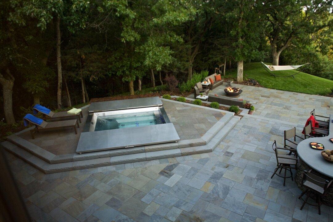 Modern patio with hot tub and fire pit.