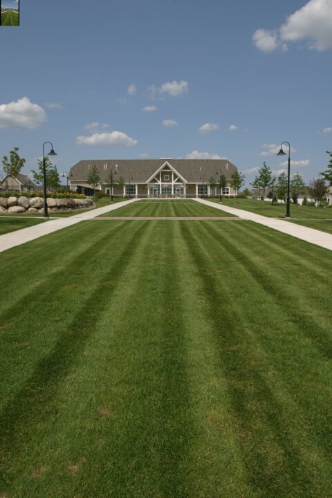 Large building with symmetrical garden and pathways.