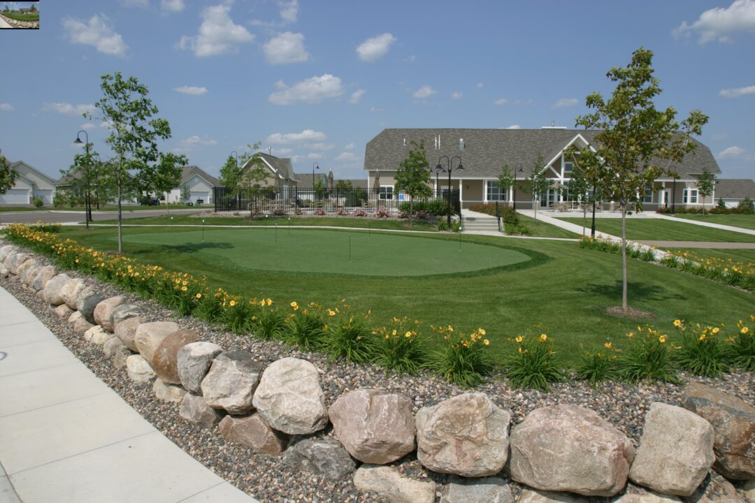 Community center with landscaped green and rocks