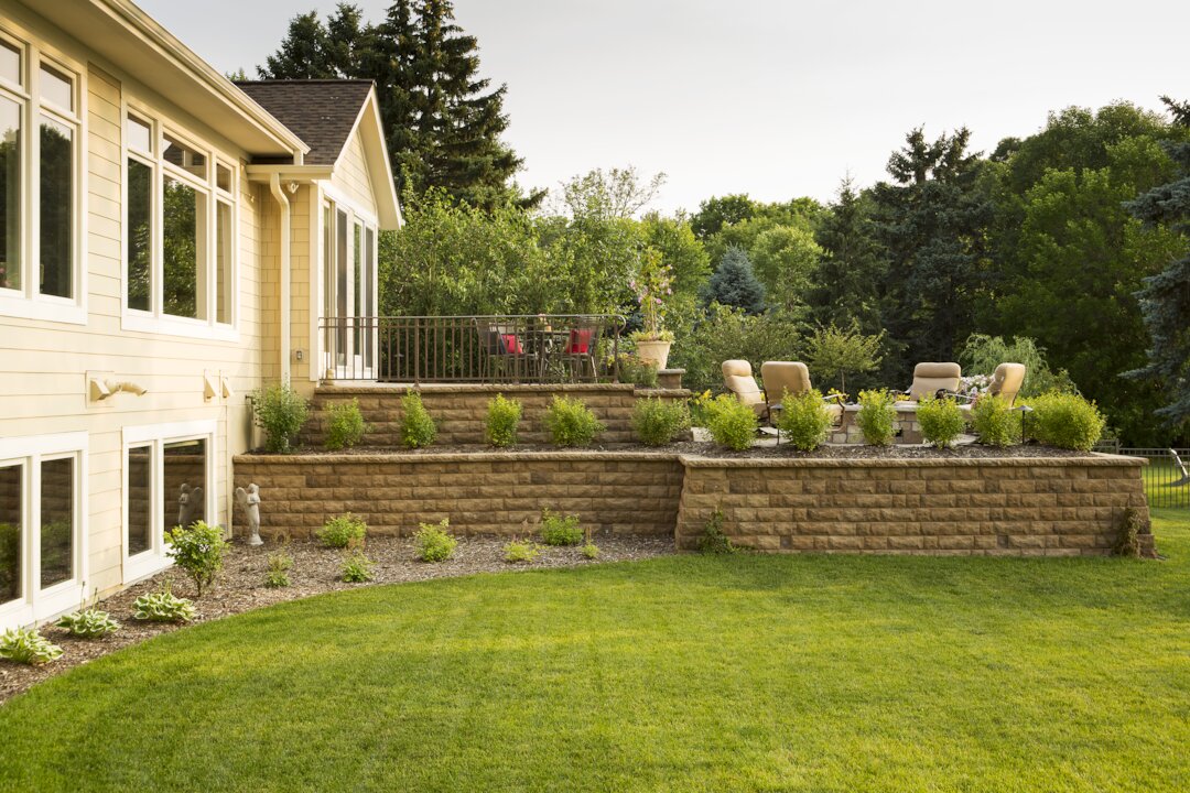 Backyard garden with patio and lawn chairs