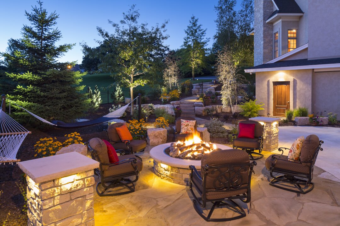 Cozy backyard patio with fire pit and hammock.