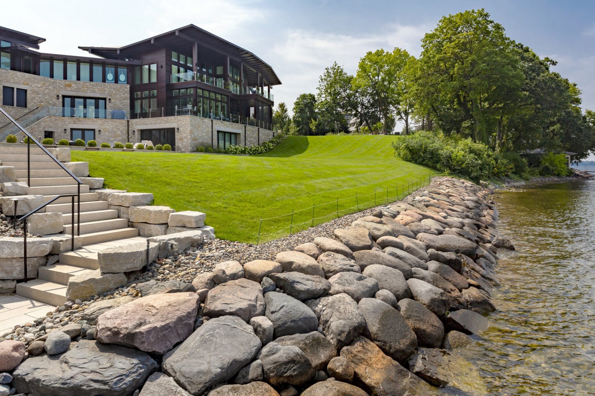 Lakeside house with stone steps and landscaping