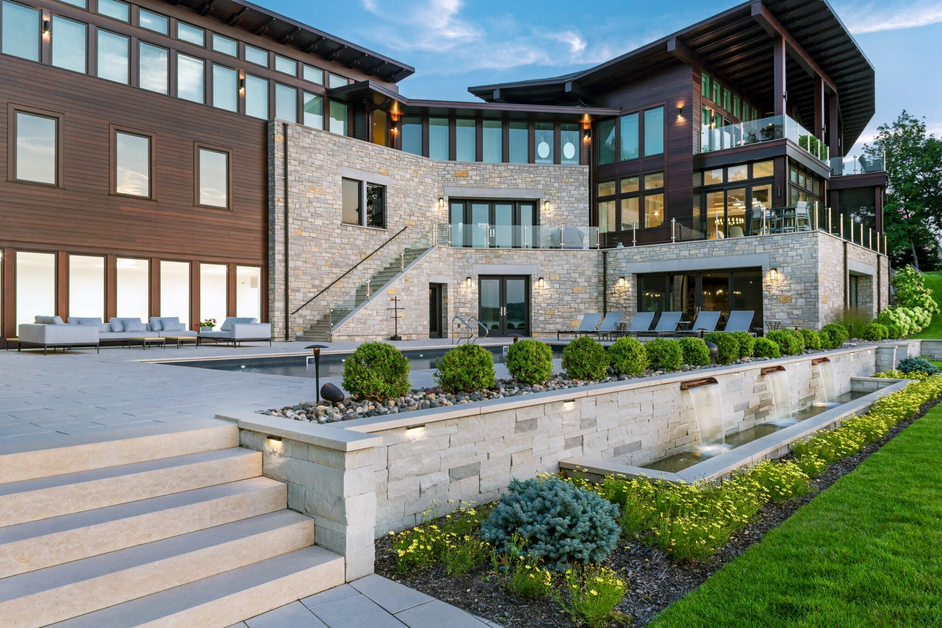 Modern luxury home exterior with glass and stone design.