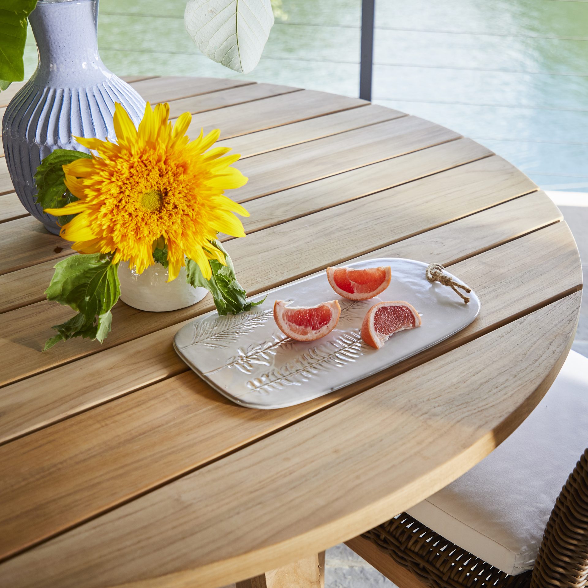 Sunflower and grapefruit slices on wooden table.