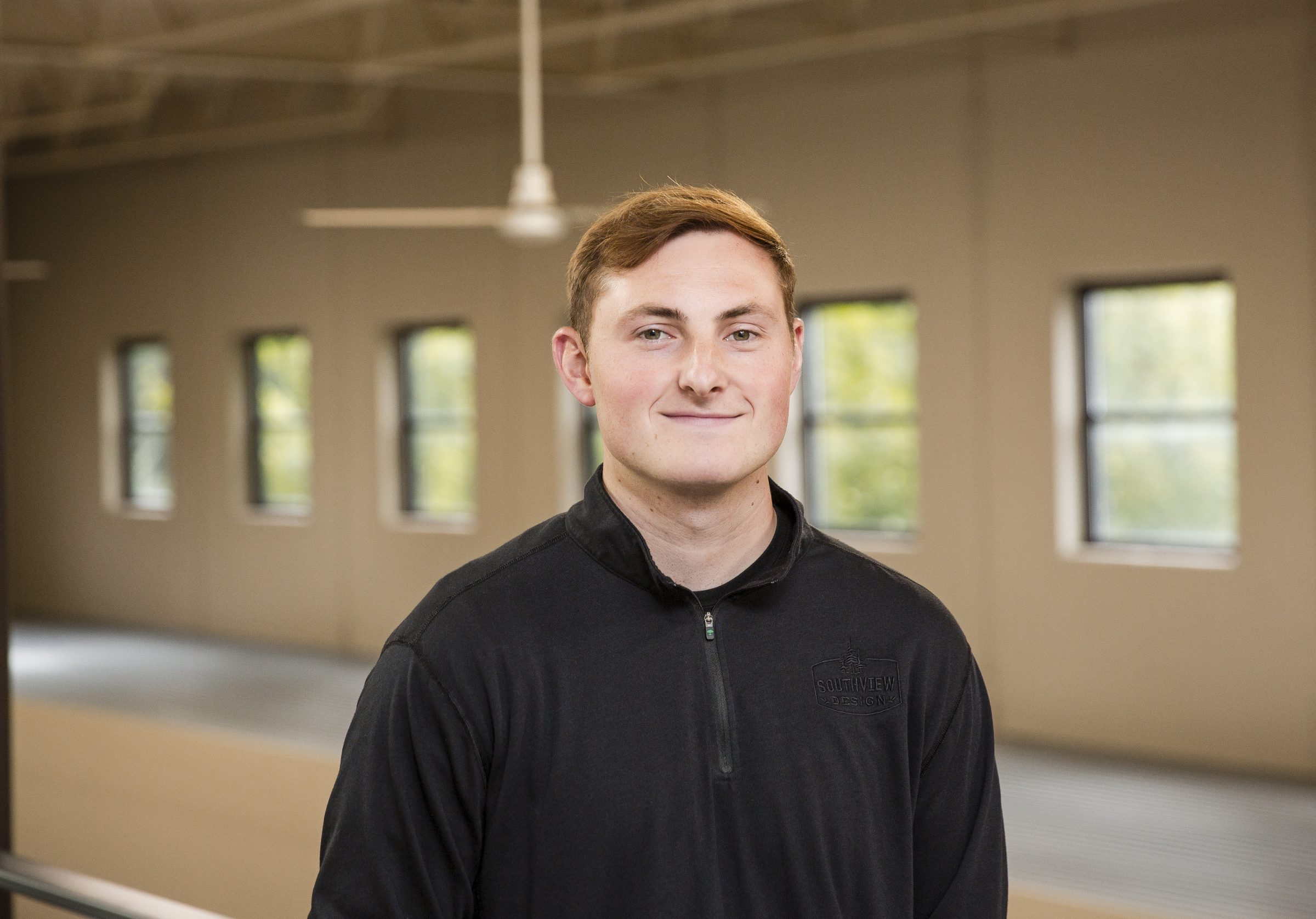 Person smiling indoors in casual attire.