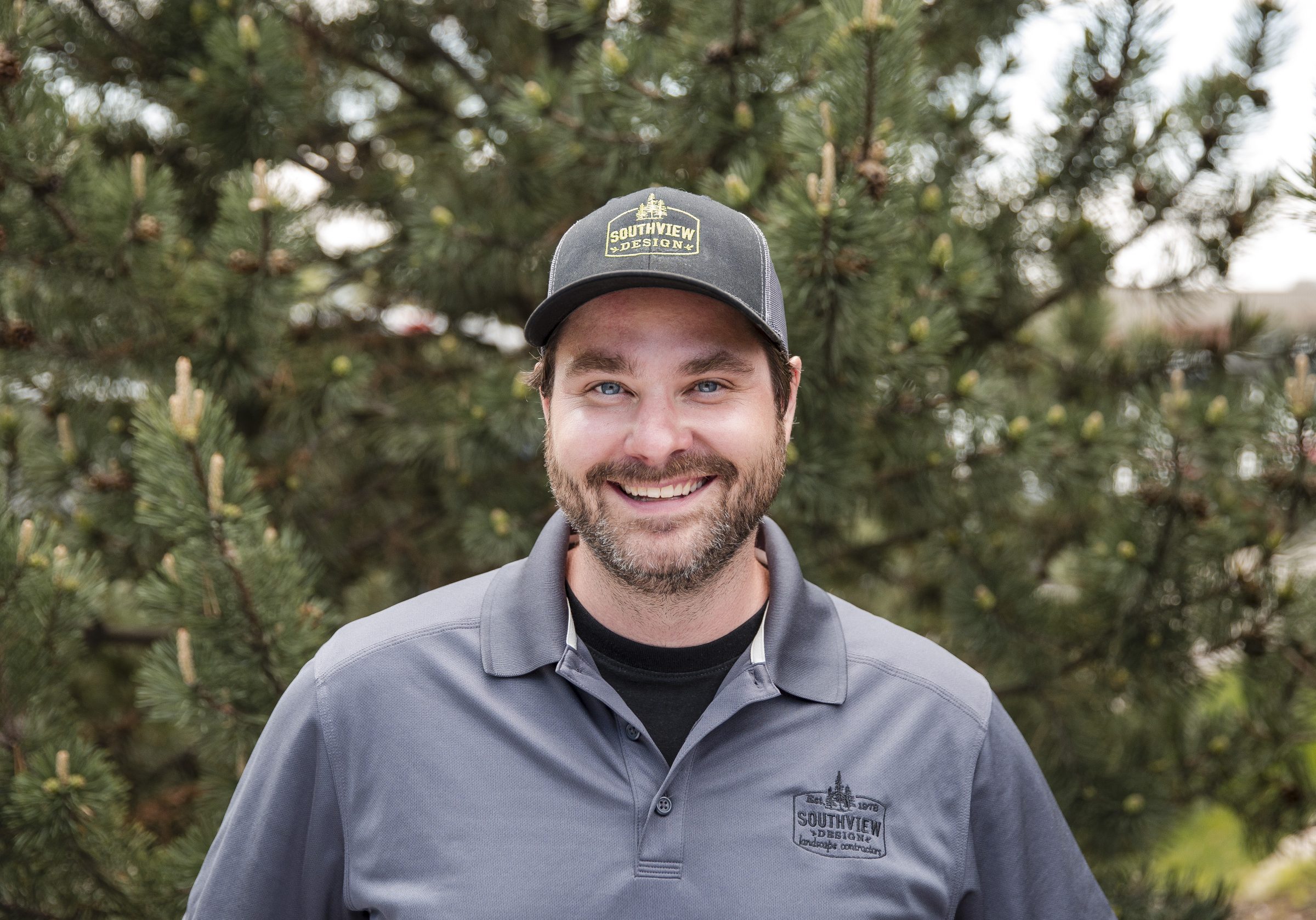 Smiling man outdoors wearing Southview Design cap.