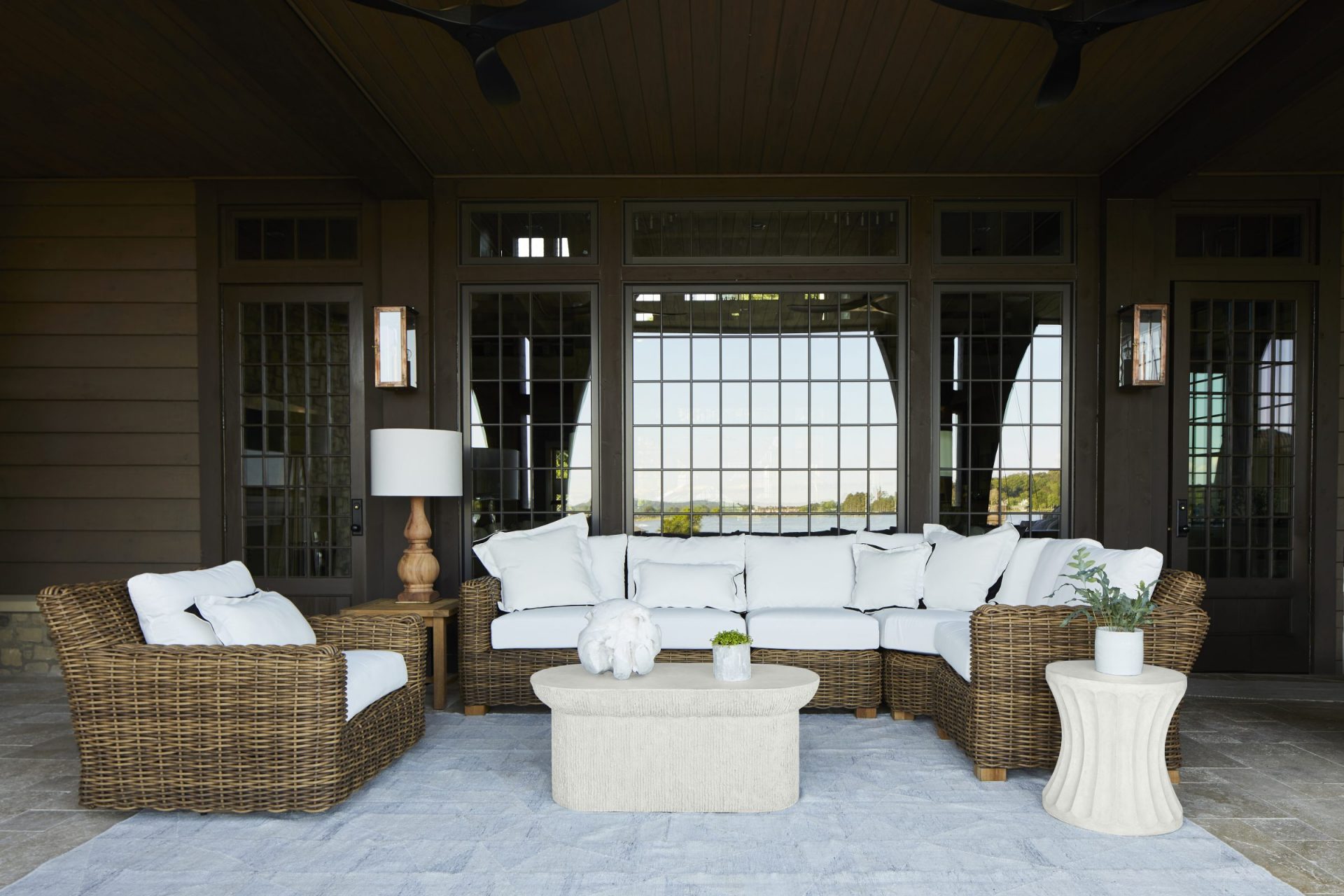 Outdoor patio with wicker furniture and cushions.