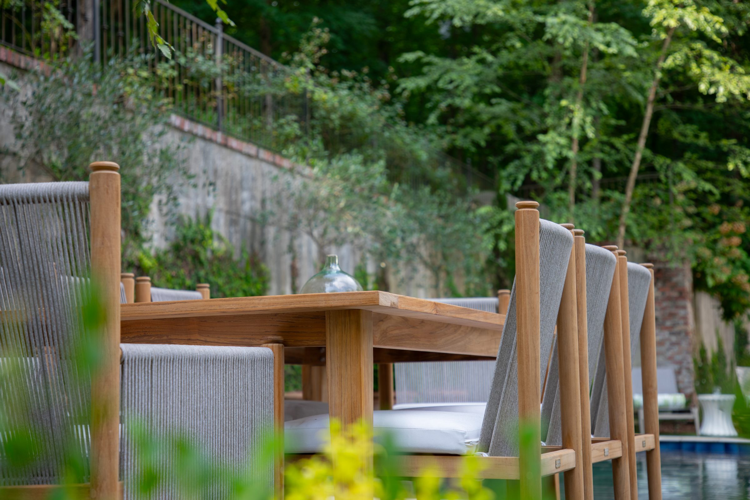 Outdoor dining set with trees in the background.