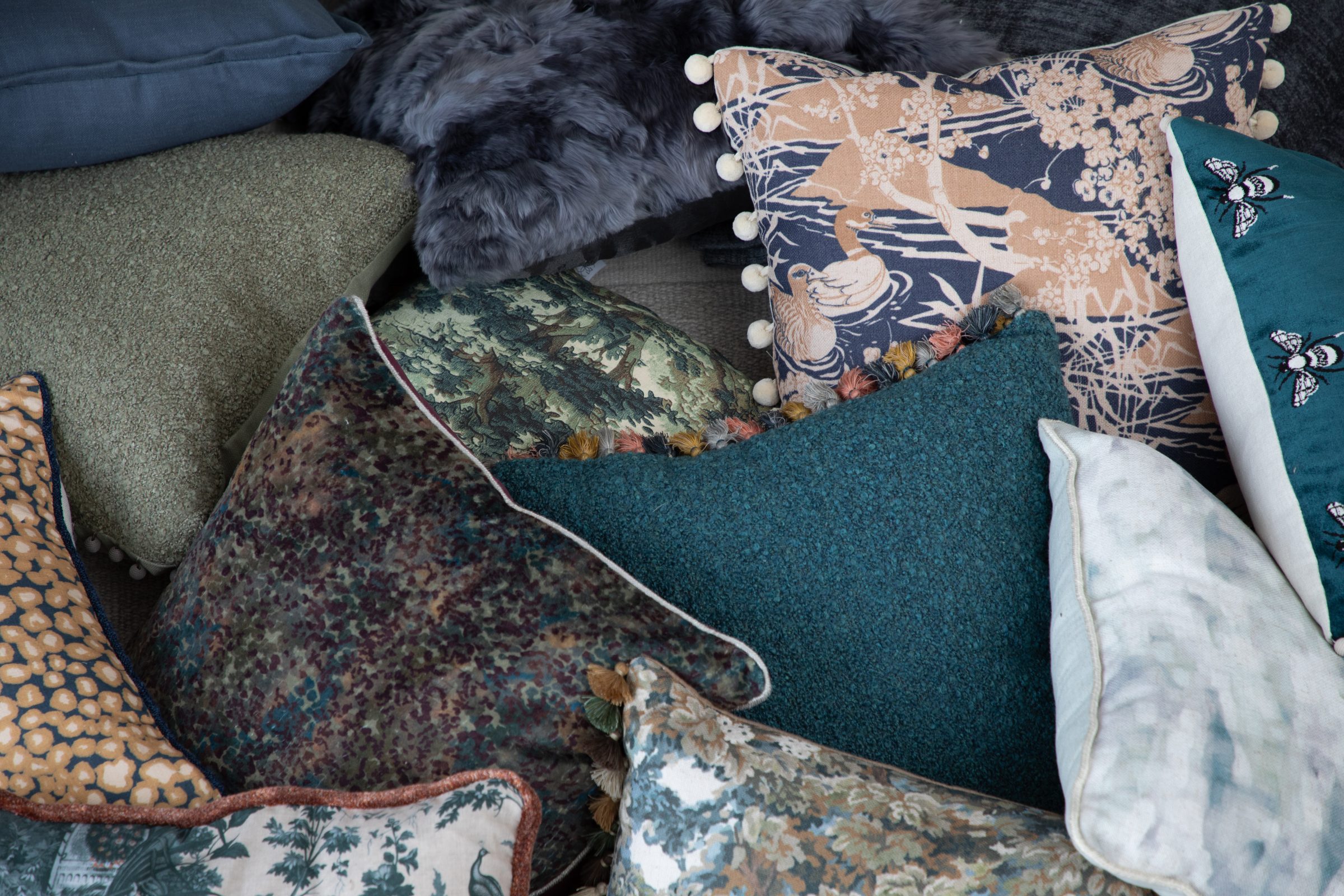 Assorted decorative pillows in various textures and colors.