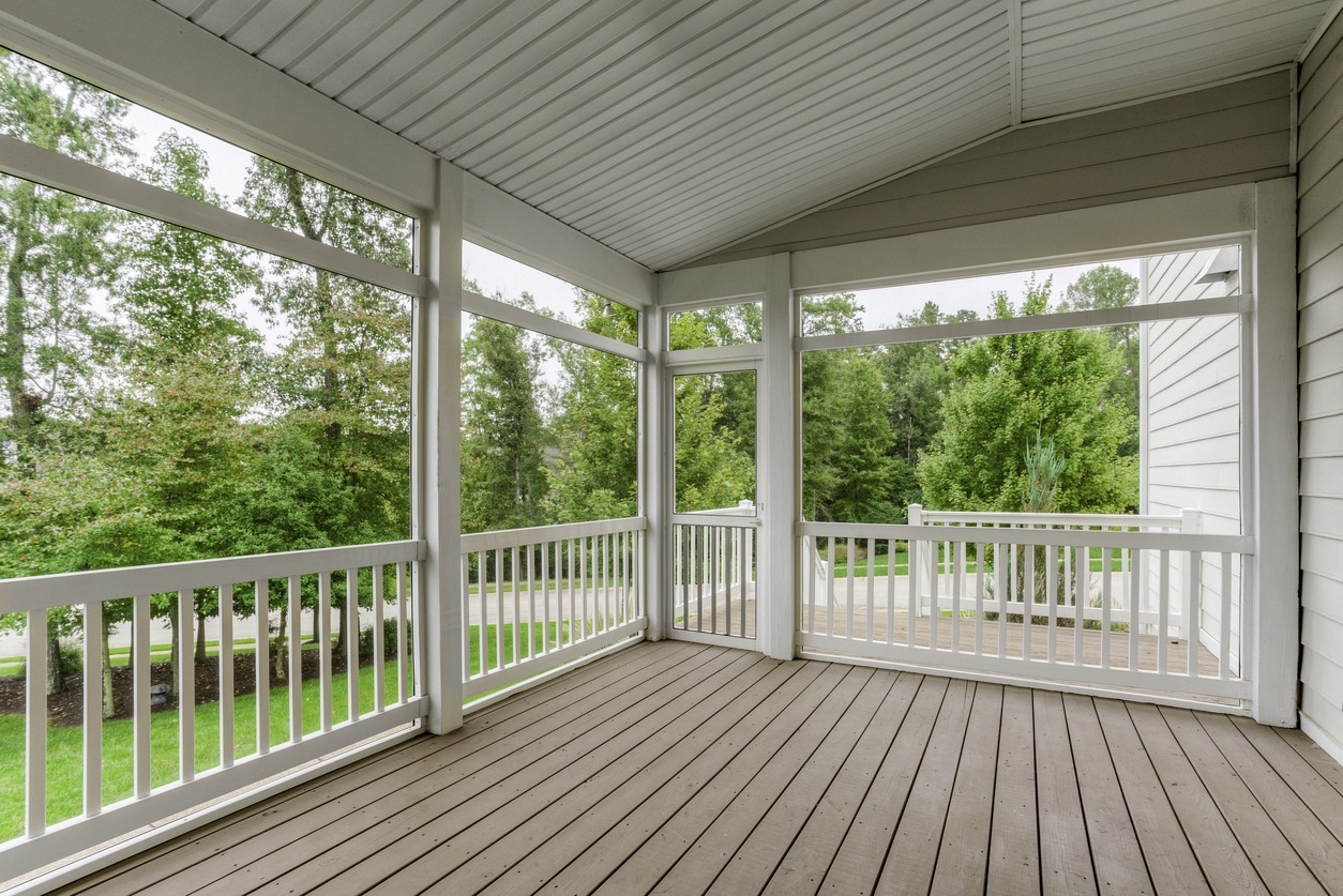 Spacious screened porch with wooded view.