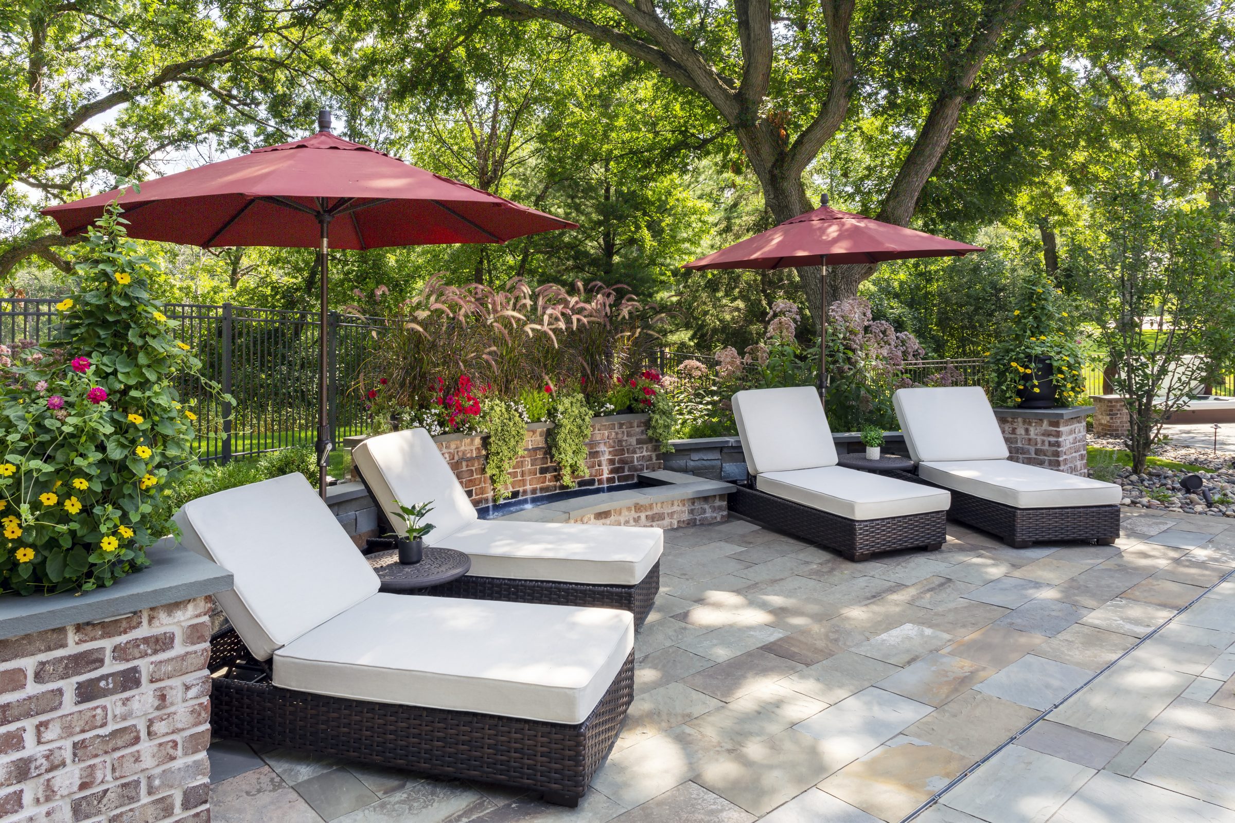 Outdoor patio with loungers and umbrellas.