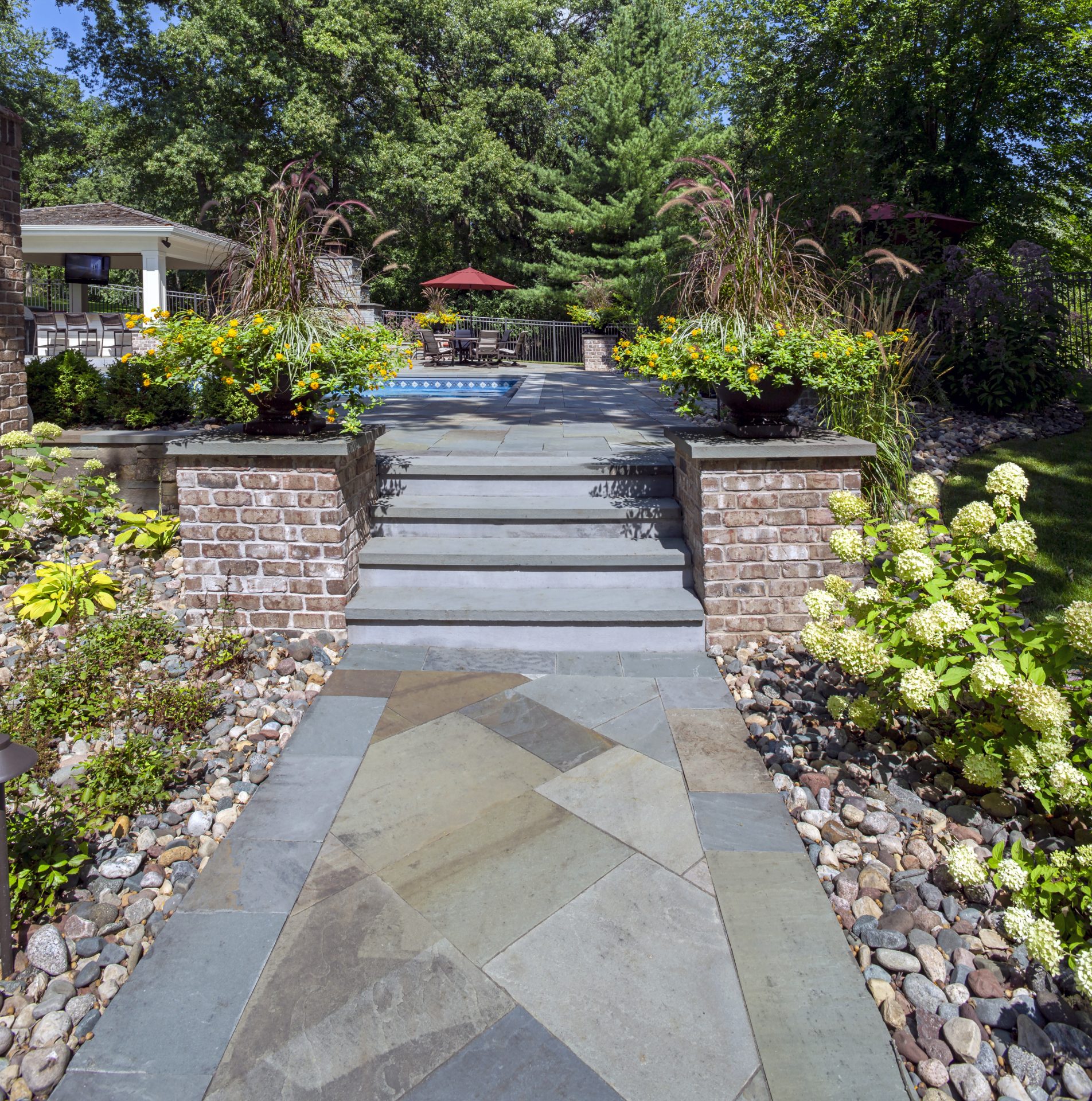 Garden pathway leading to patio and pool area.