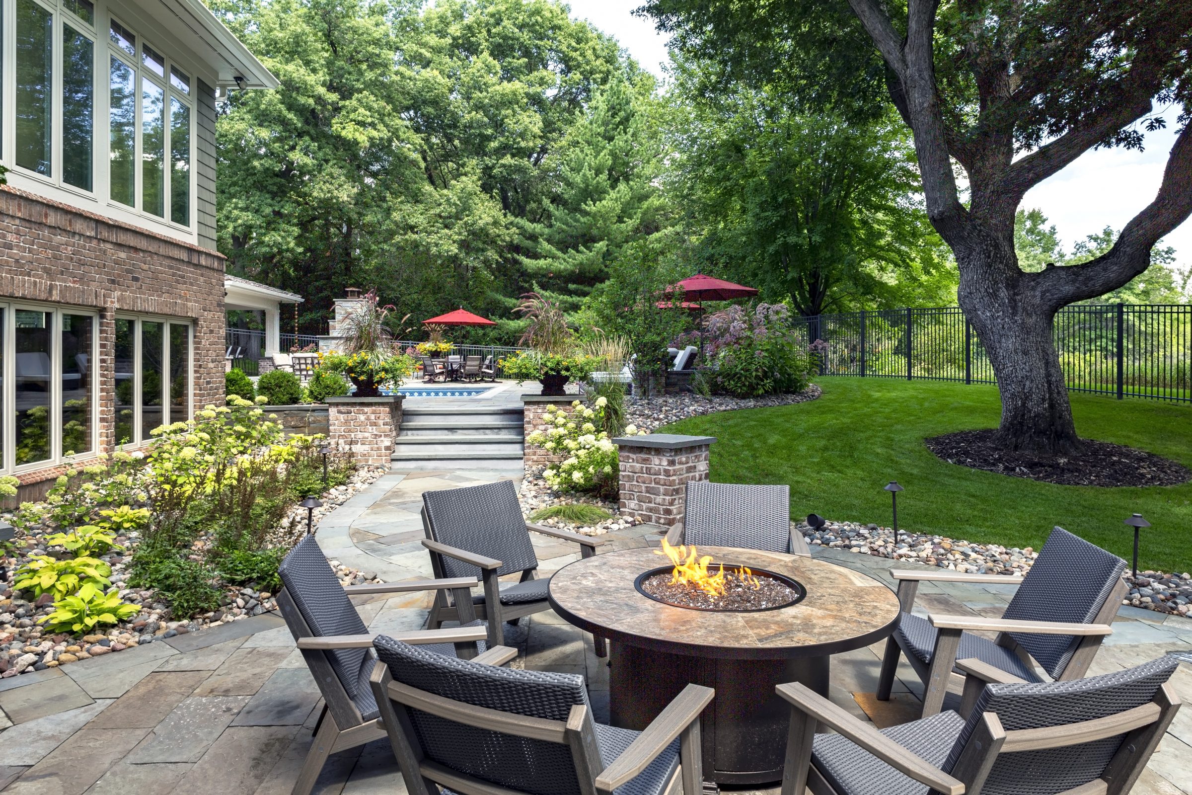 Cozy patio with fire pit and garden view.