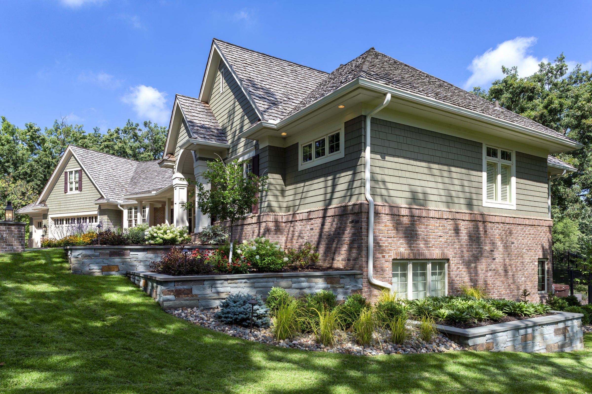 Modern house with landscaped garden and lawn.
