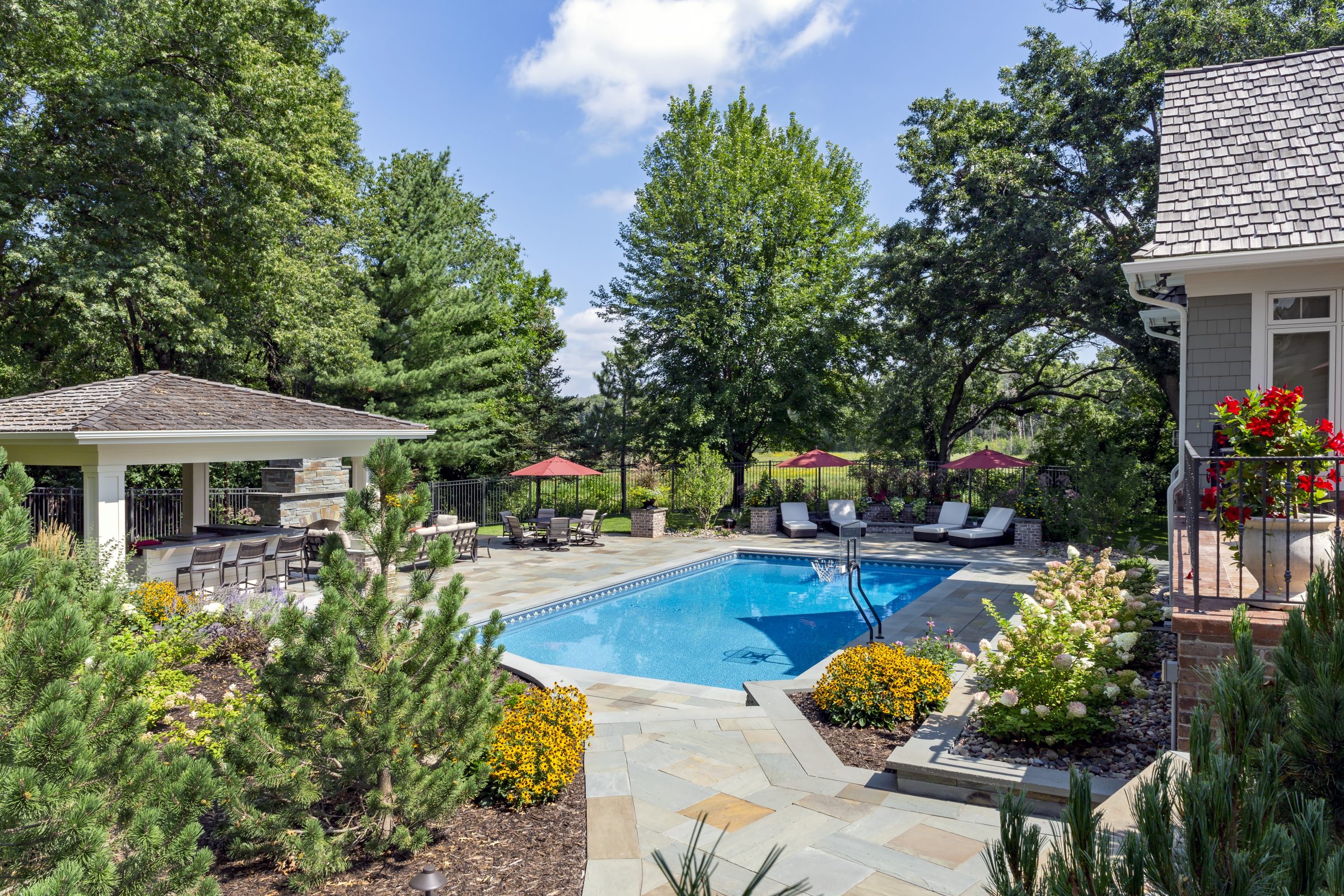 Backyard swimming pool with patio and lounge chairs