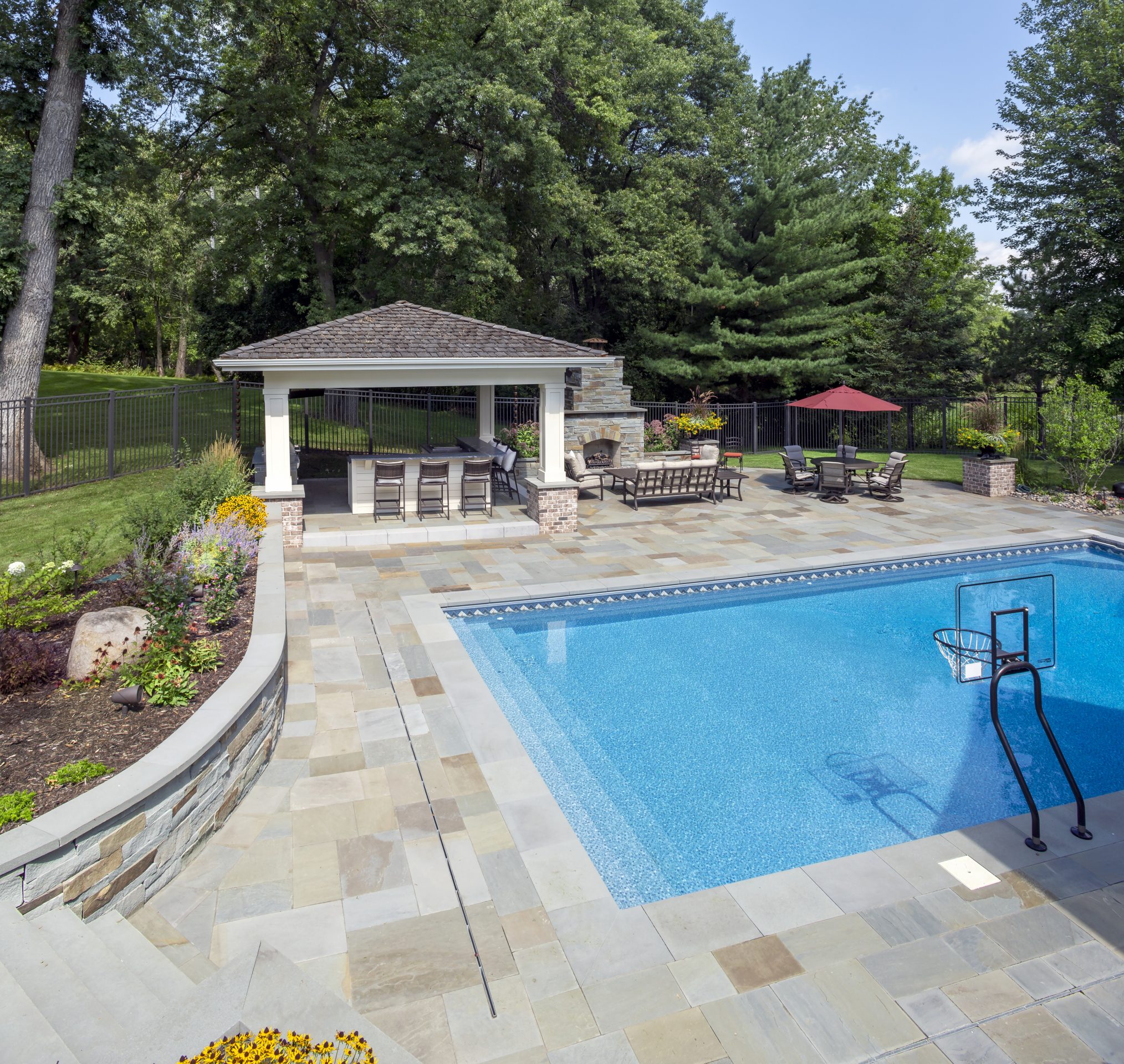 Backyard pool with patio and outdoor gazebo area.