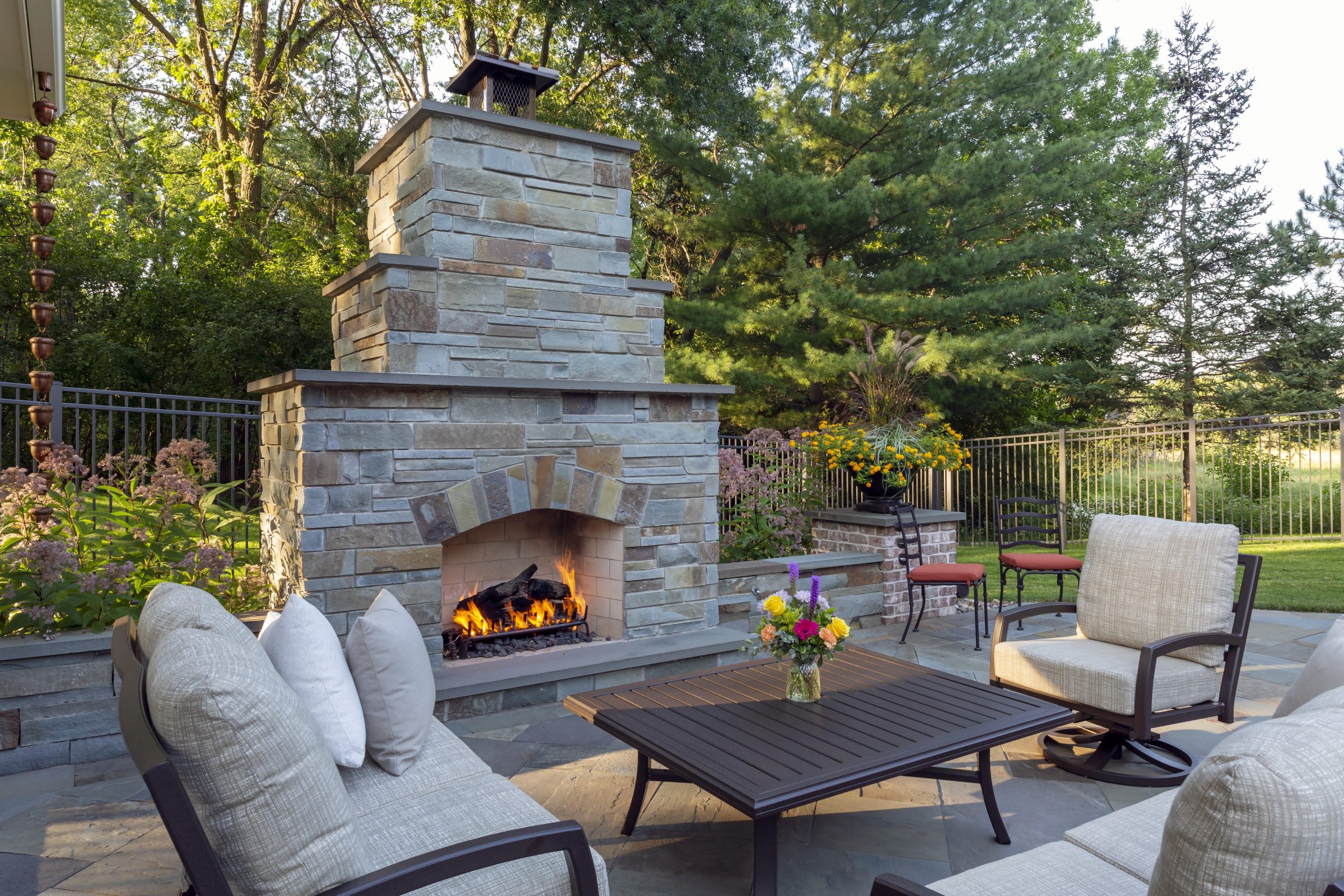 Cozy patio with fireplace and outdoor seating.