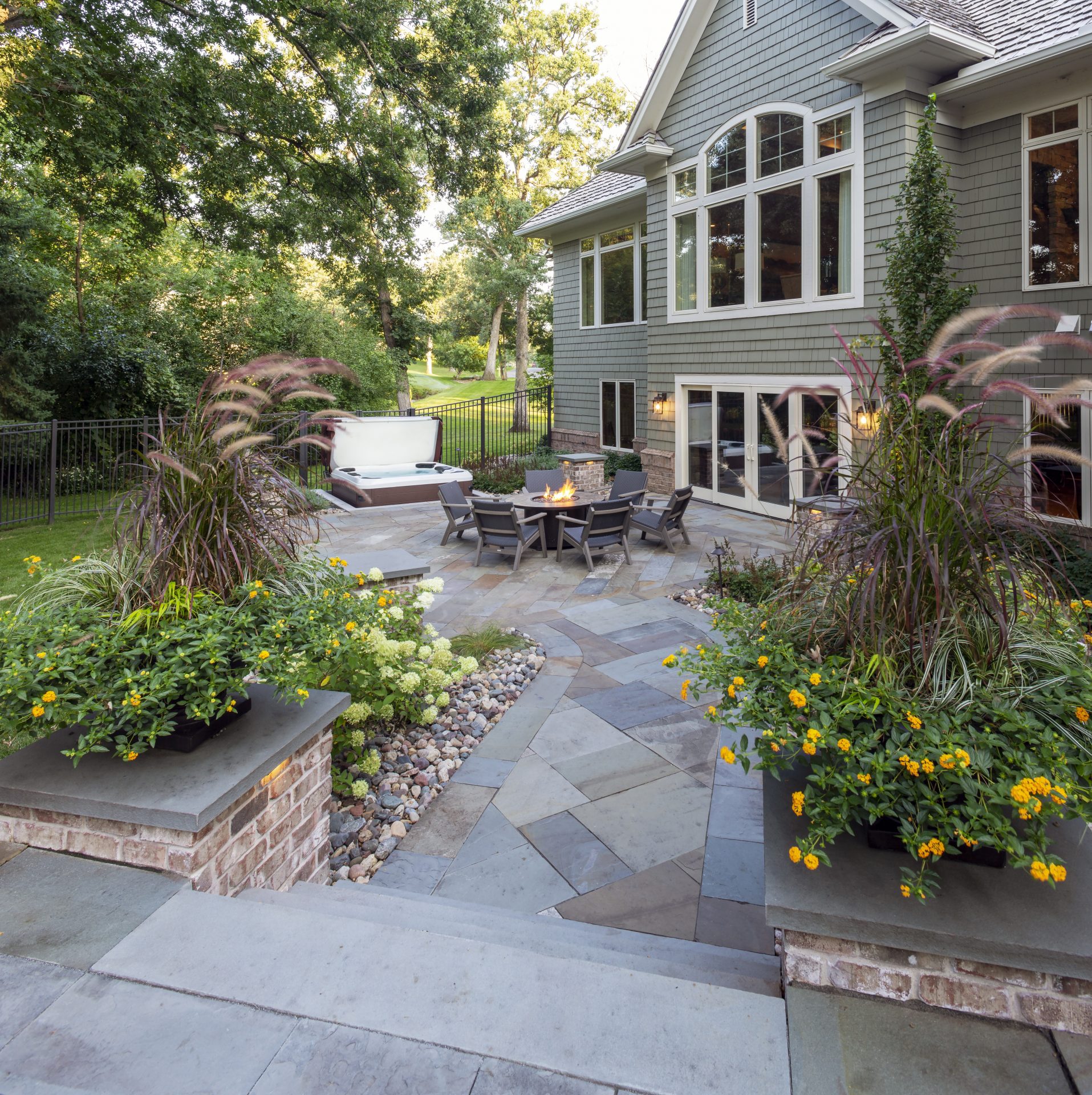 Backyard patio with fire pit and seating area.