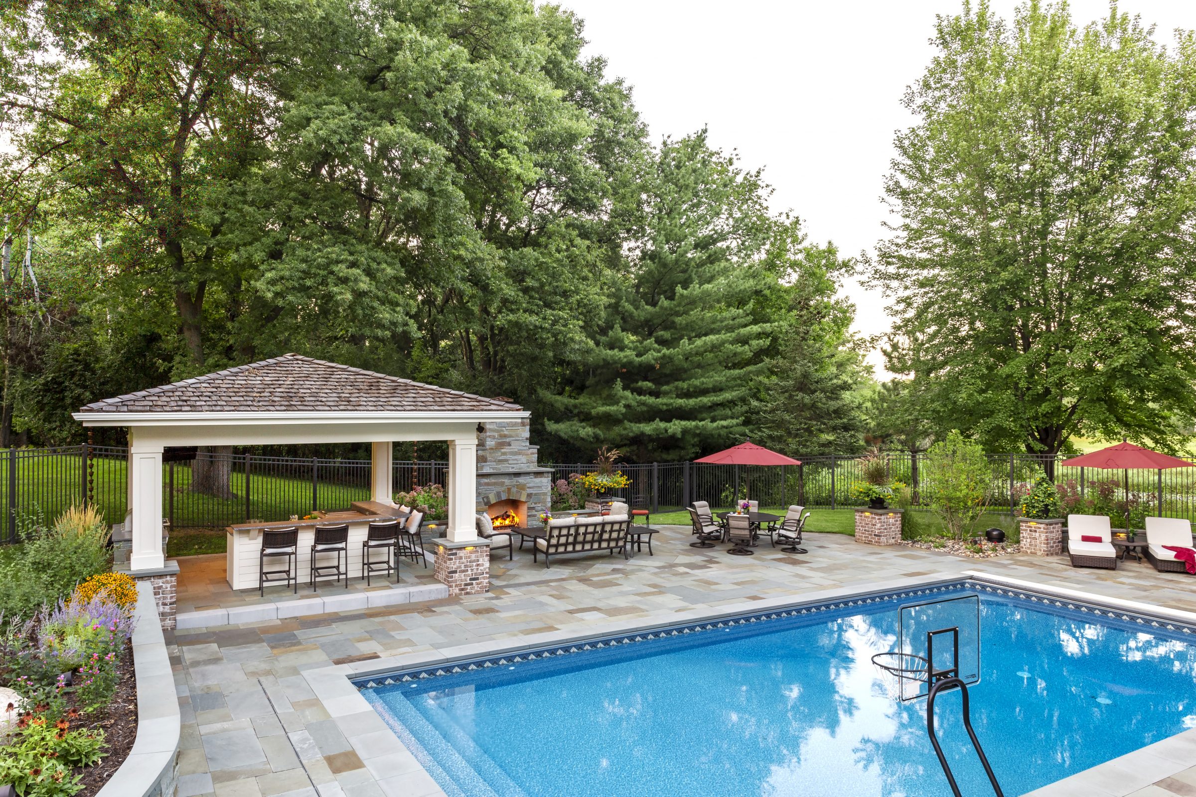 Beautiful backyard pool with seating area and garden.