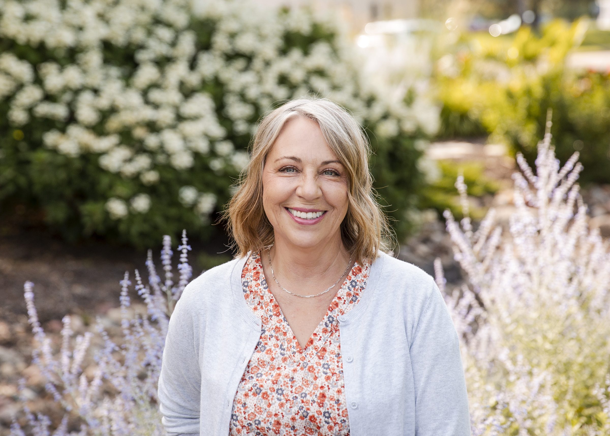 Smiling woman in floral dress outside