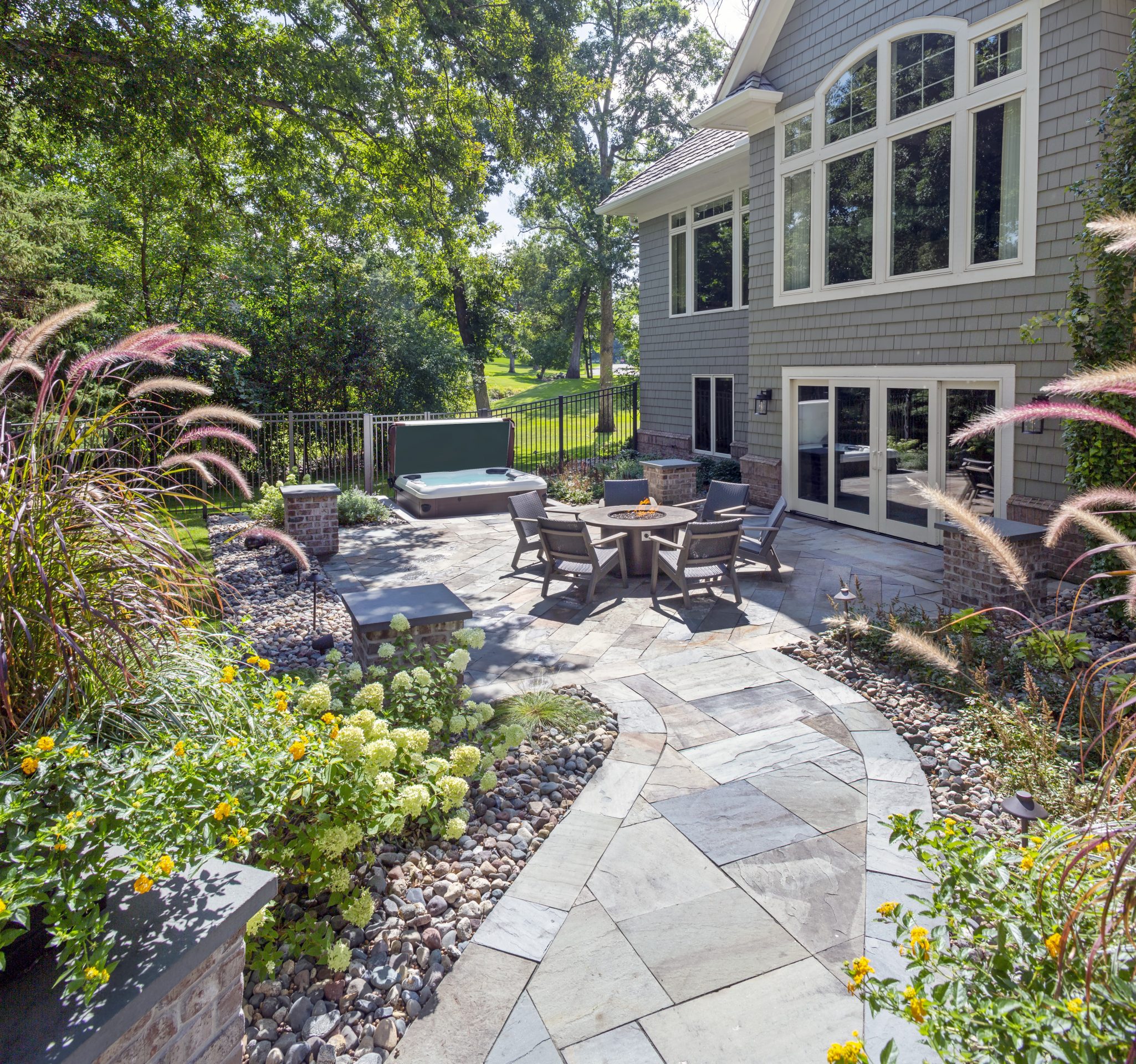 Backyard patio with seating and garden view.
