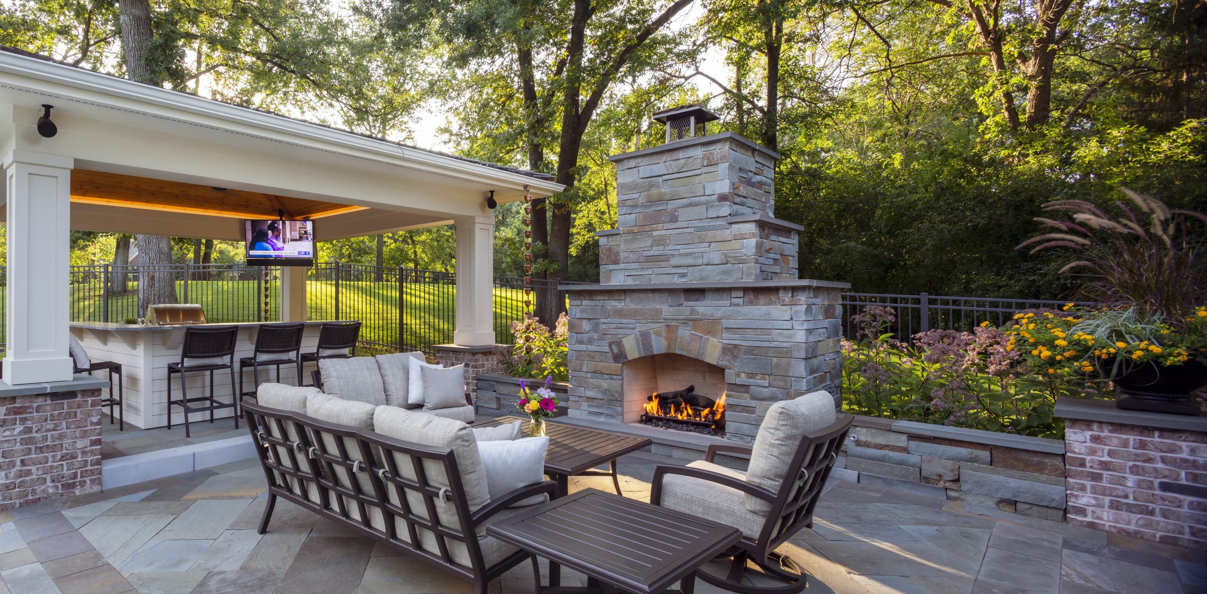 Outdoor patio with fireplace and seating area.