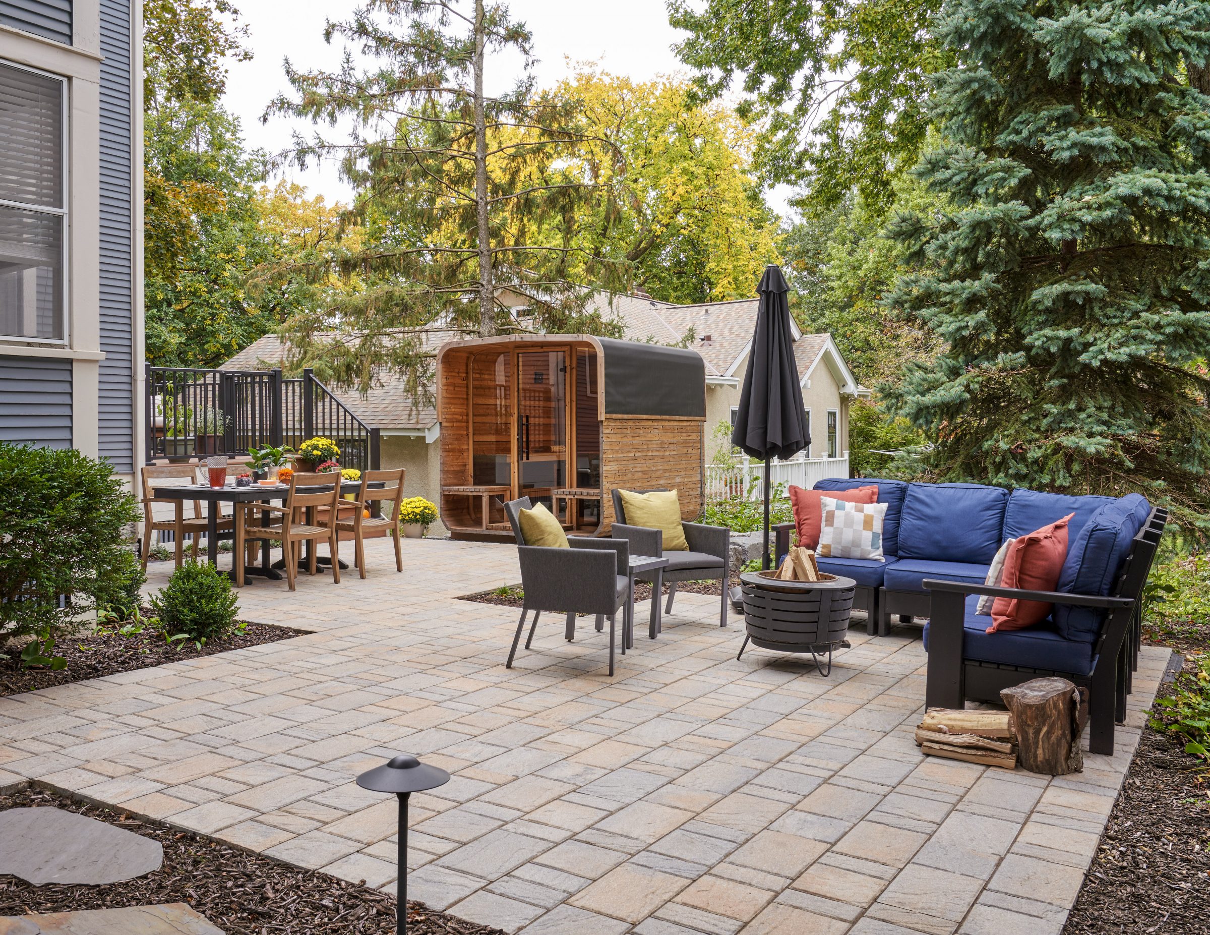 Cozy outdoor patio with seating and greenery.