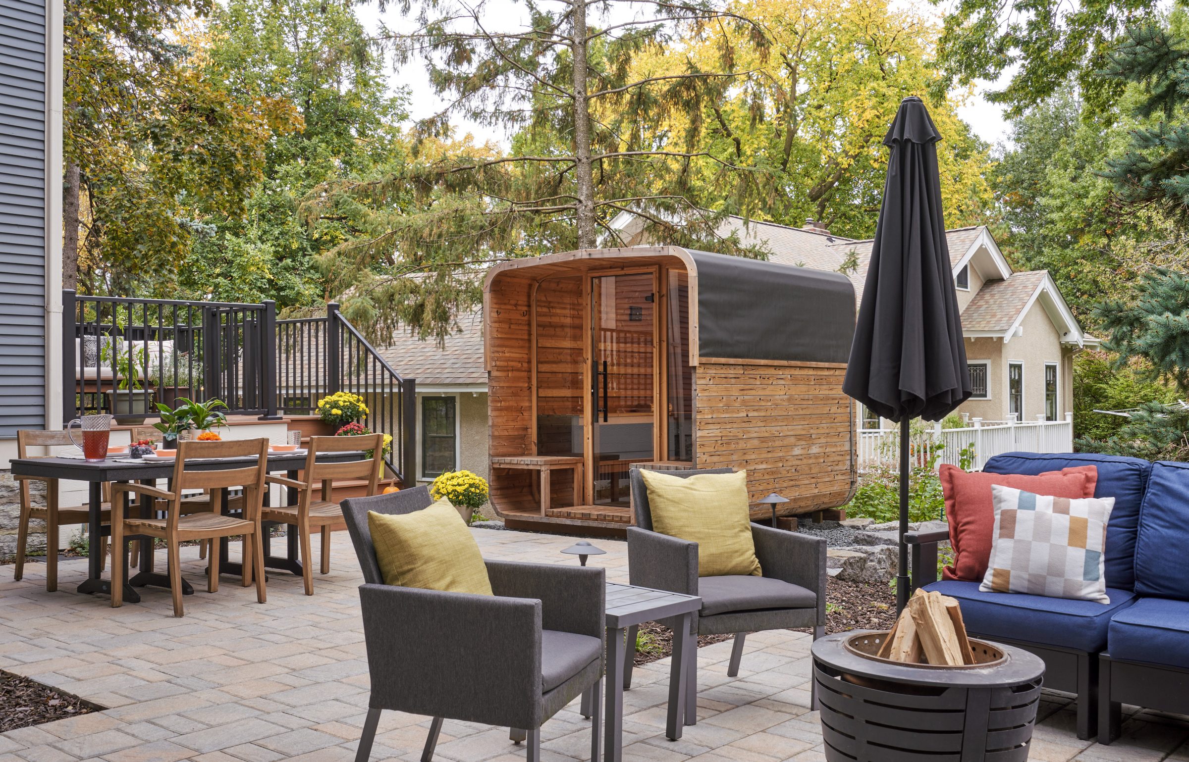 Cozy backyard with patio furniture and wood sauna.
