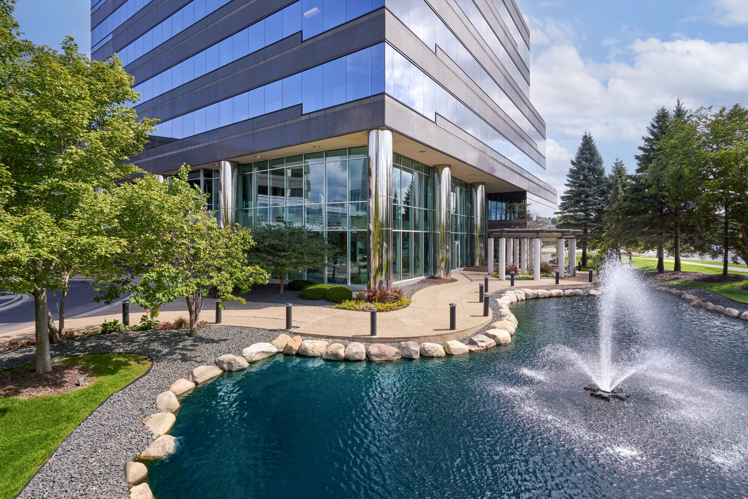 ffice building entrance with pond, fountain, and landscaped walkway at Normandale Lakes Office Park