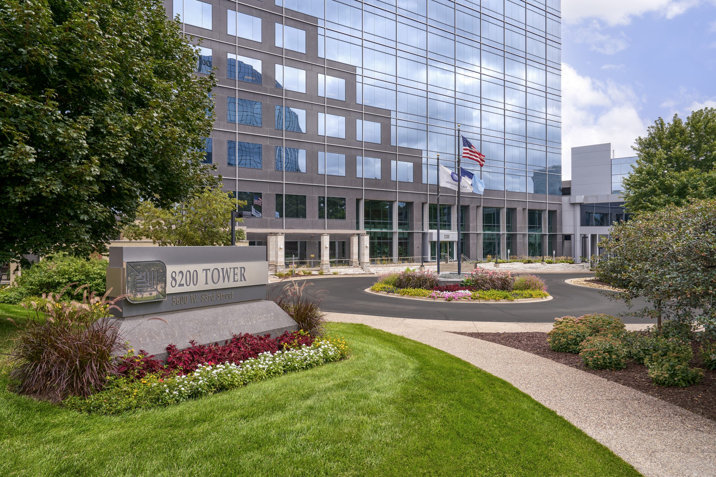 Normandale Lakes Office Park entrance sign surrounded by landscaped plantings