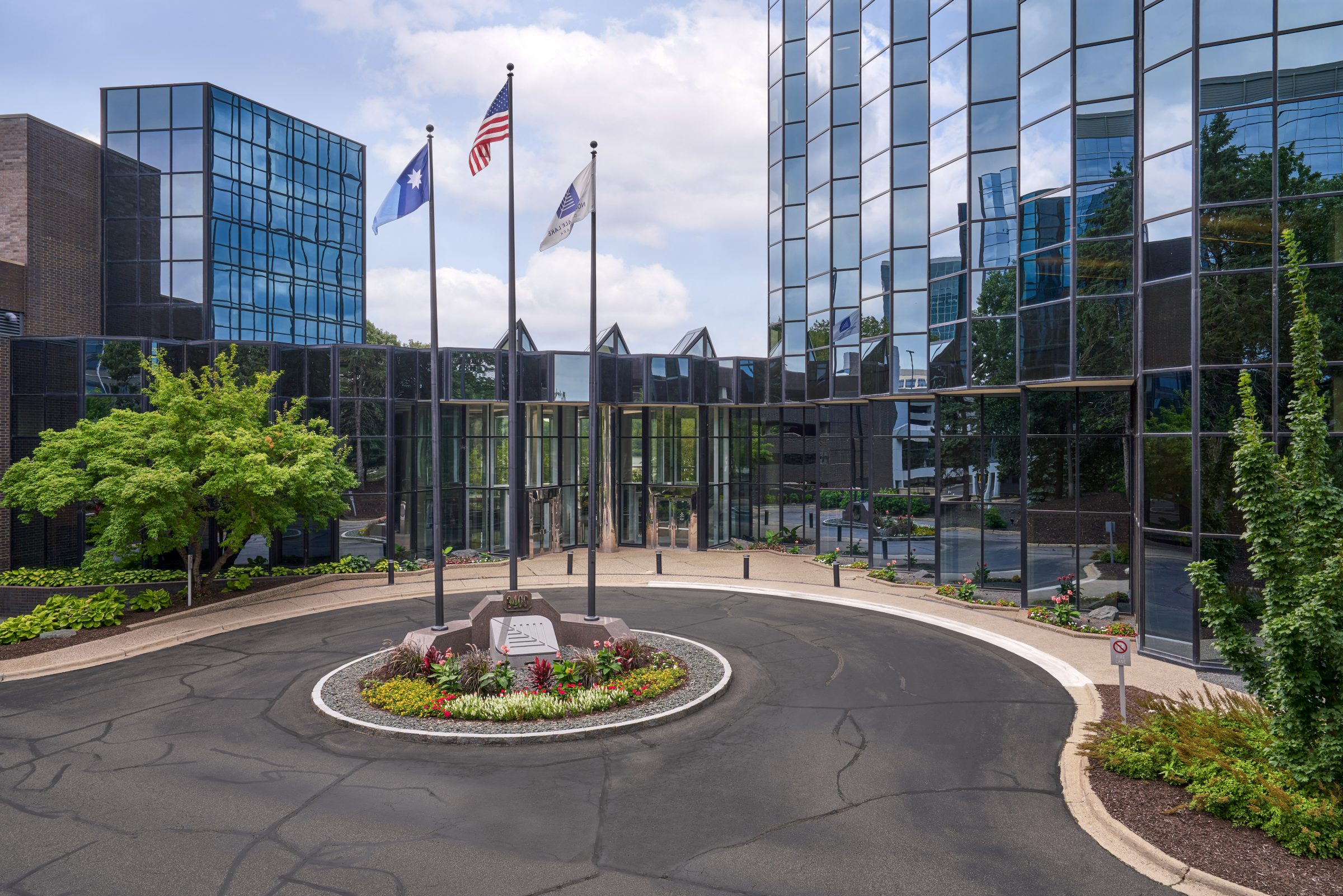 Flagpole roundabout with seasonal color planting island at the Normandale Lakes Office Park entrance