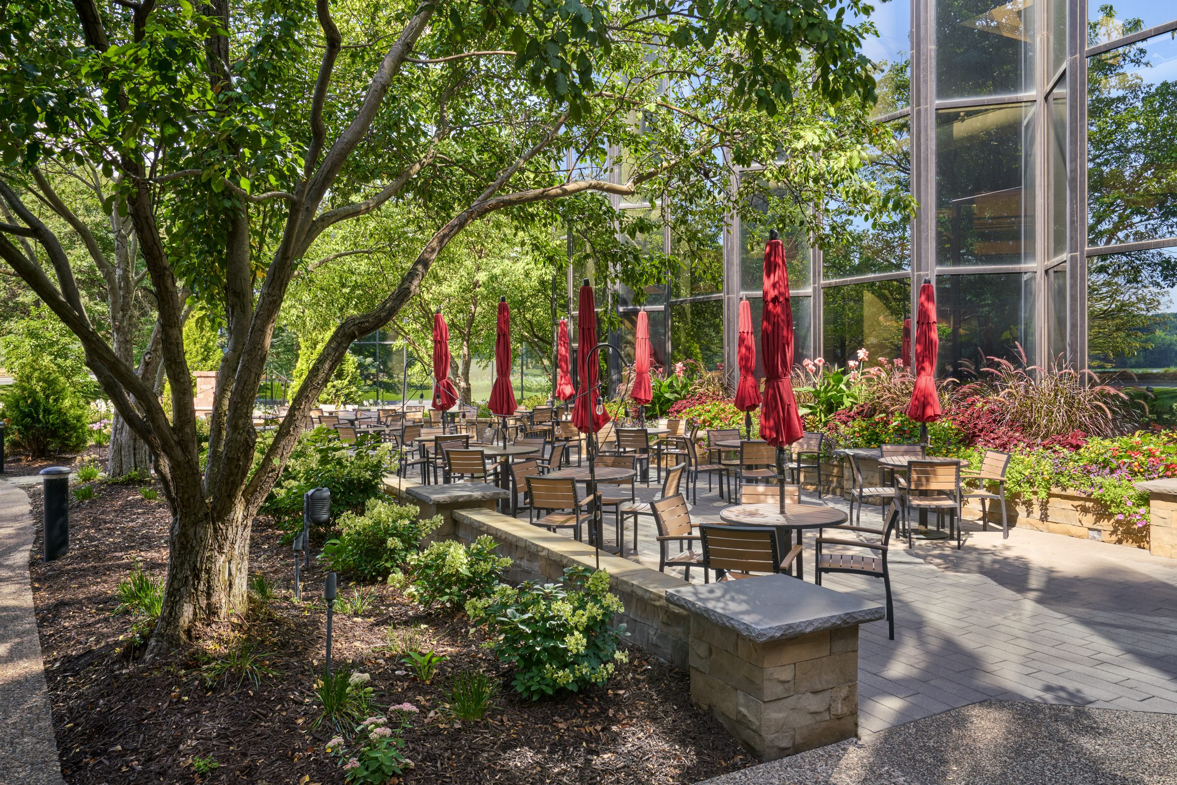 Shaded outdoor seating area along a landscaped walkway at Normandale Lakes Office Park