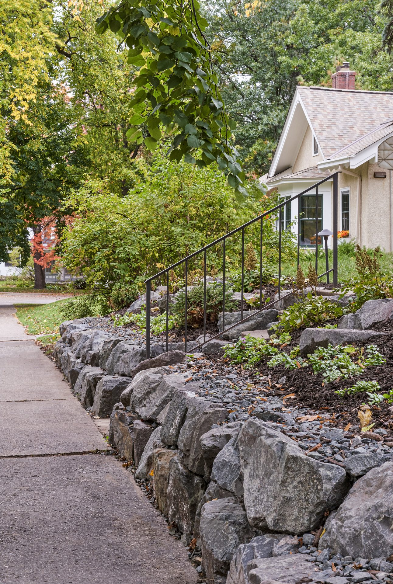 House with garden and stone walkway